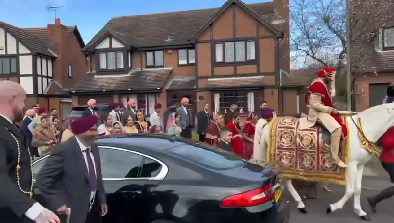 Bhangra dancers leading a baraat