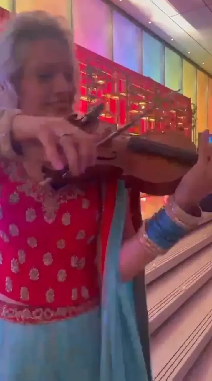 Violinist playing among guests, the UK