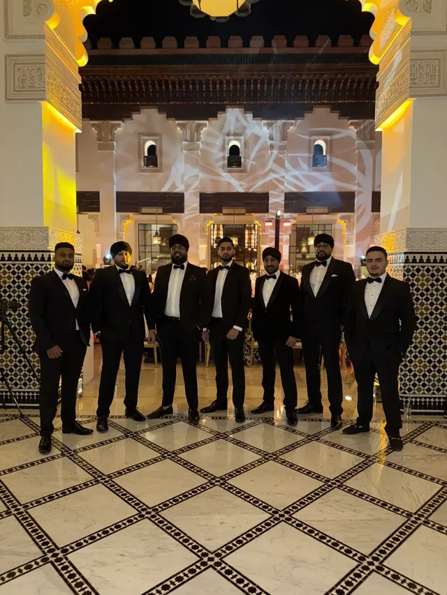 Dhol team in black tie at a luxury venue