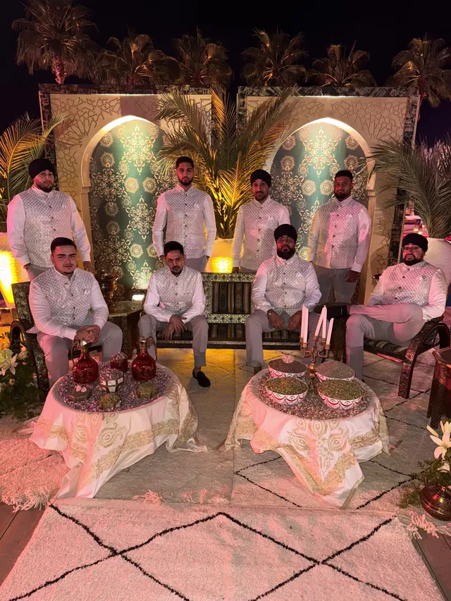 Dhol team in white sherwanis at a mehndi set-up abroad