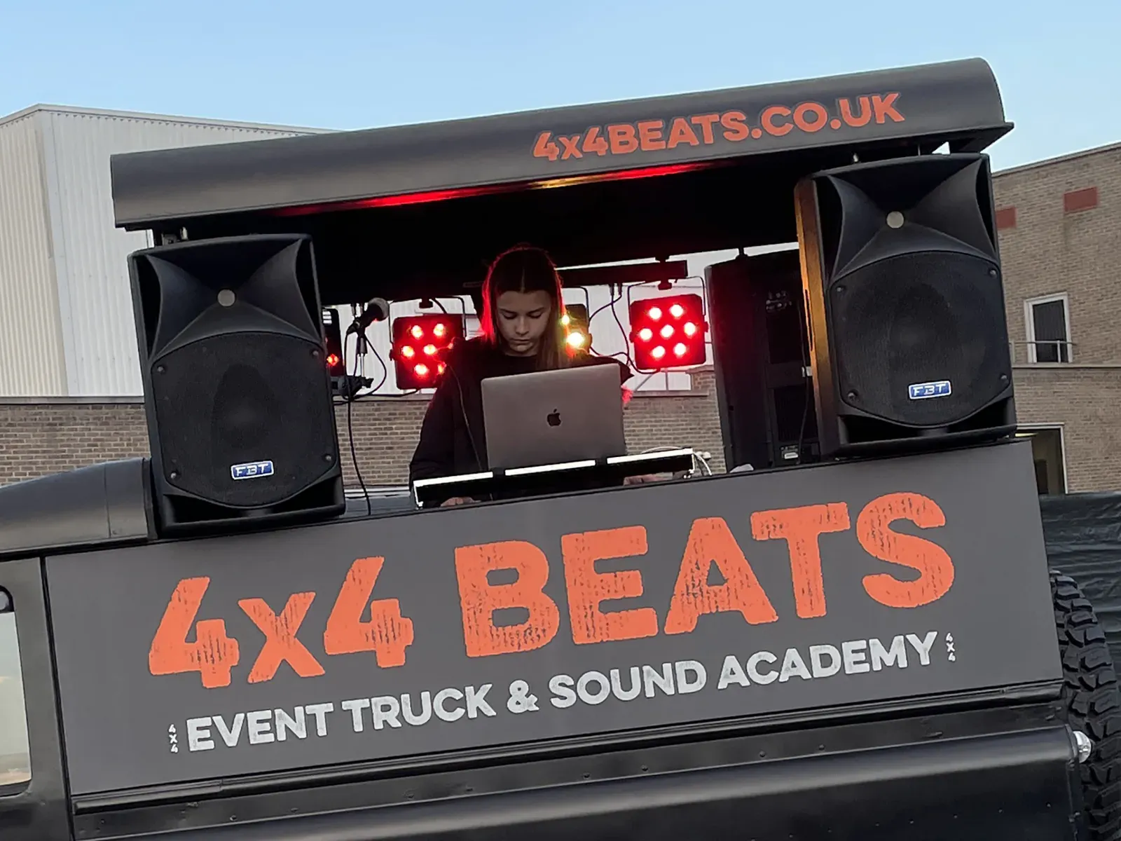 DJ performing from the booth on top of the truck