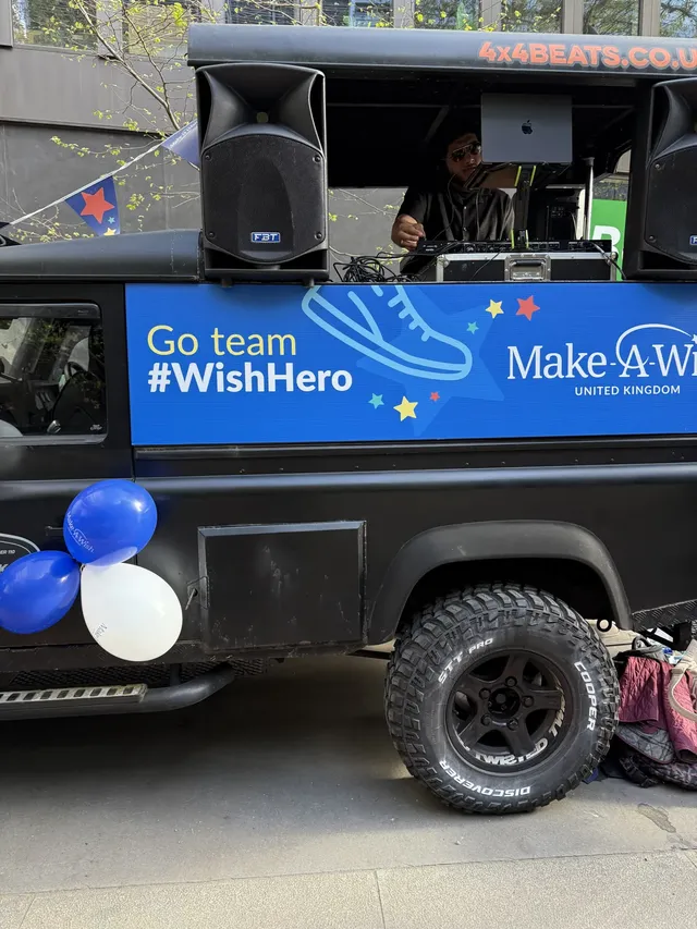 DJ playing from the roof of a charity-branded truck