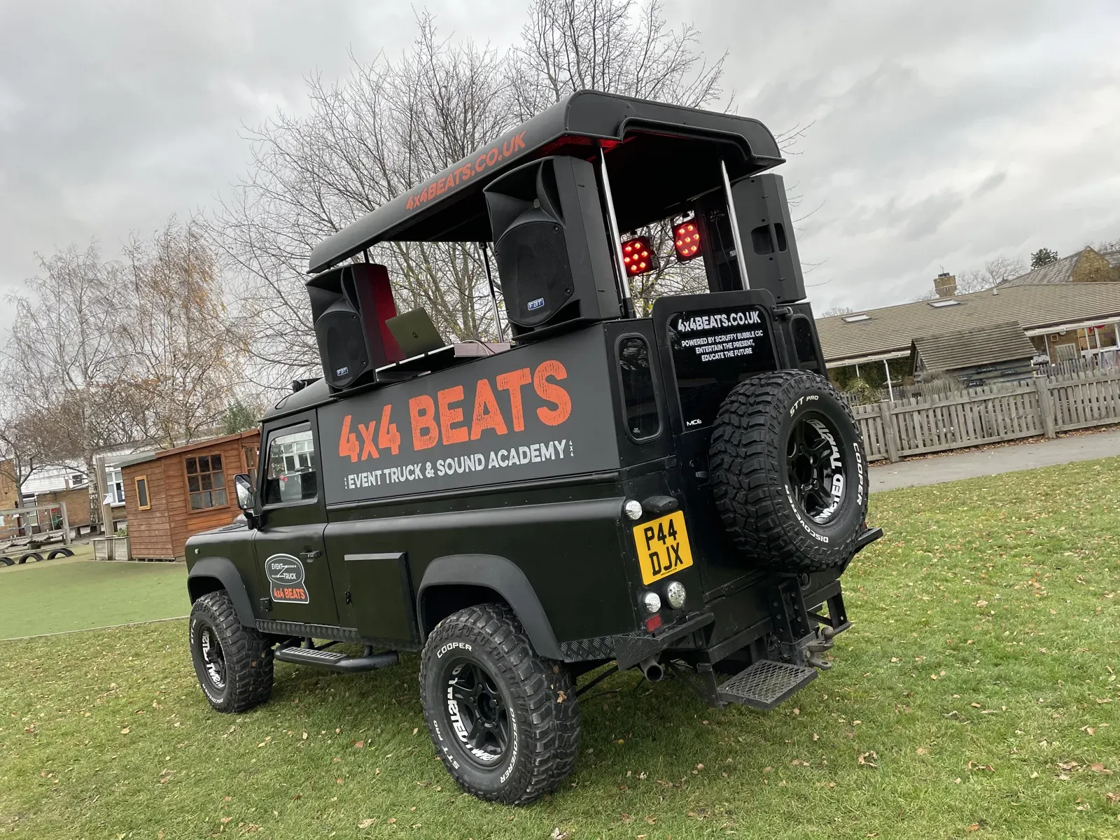 Black DJ truck with a roof-mounted sound system