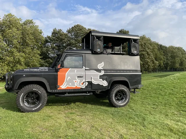 DJ truck with roof sound system parked on a lawn