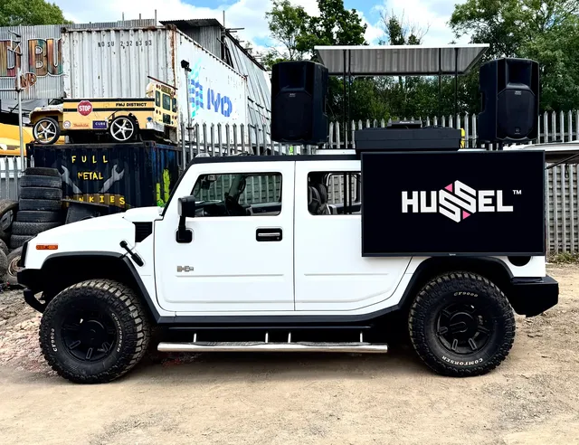 White DJ truck with a branded roof booth