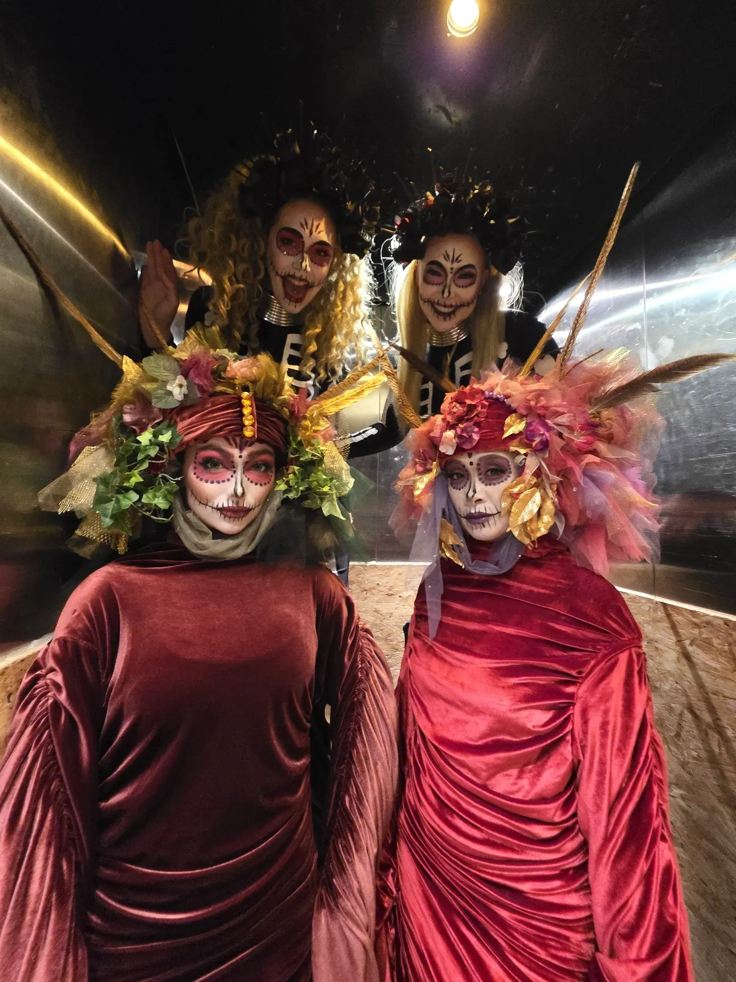 Floral venetians day of the dead with skeleton stilts: living statues