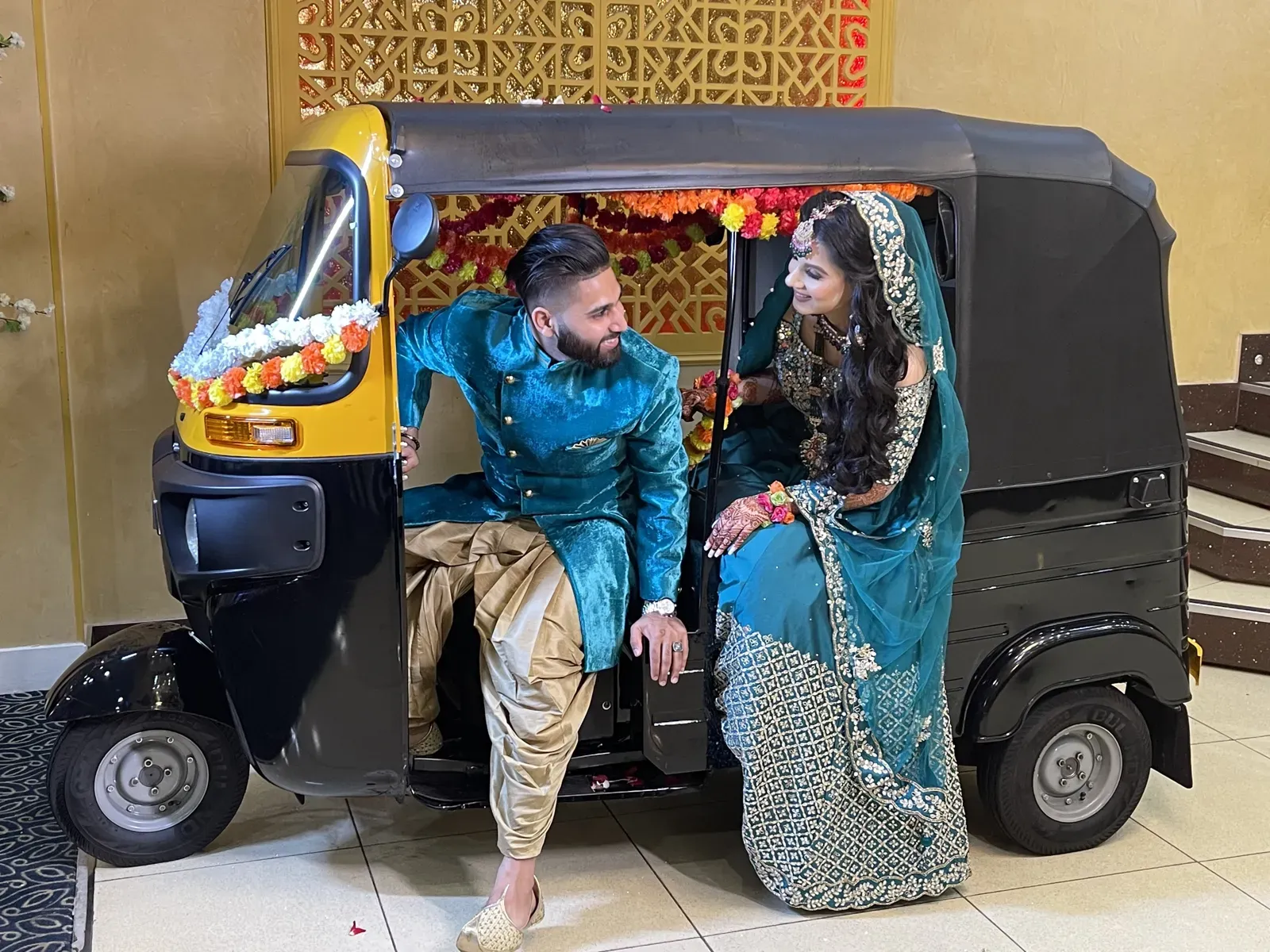 Bride and groom sitting in a decorated tuk tuk
