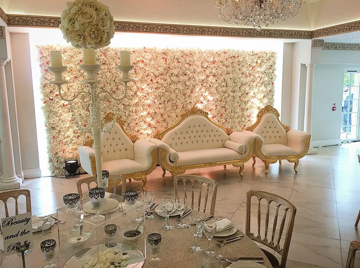 Flower wall stage with ornate sofas