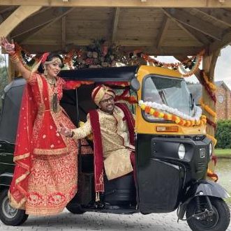 Bride and groom arriving in a decorated tuk tuk
