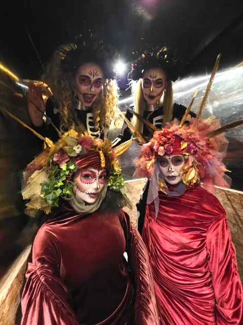 Floral venetians day of the dead with skeleton stilts: living statues