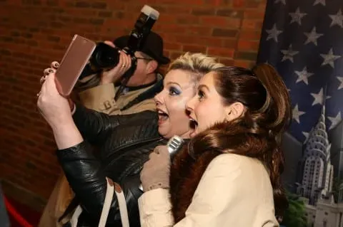 Showbiz interviewer greeting guests on a red carpet
