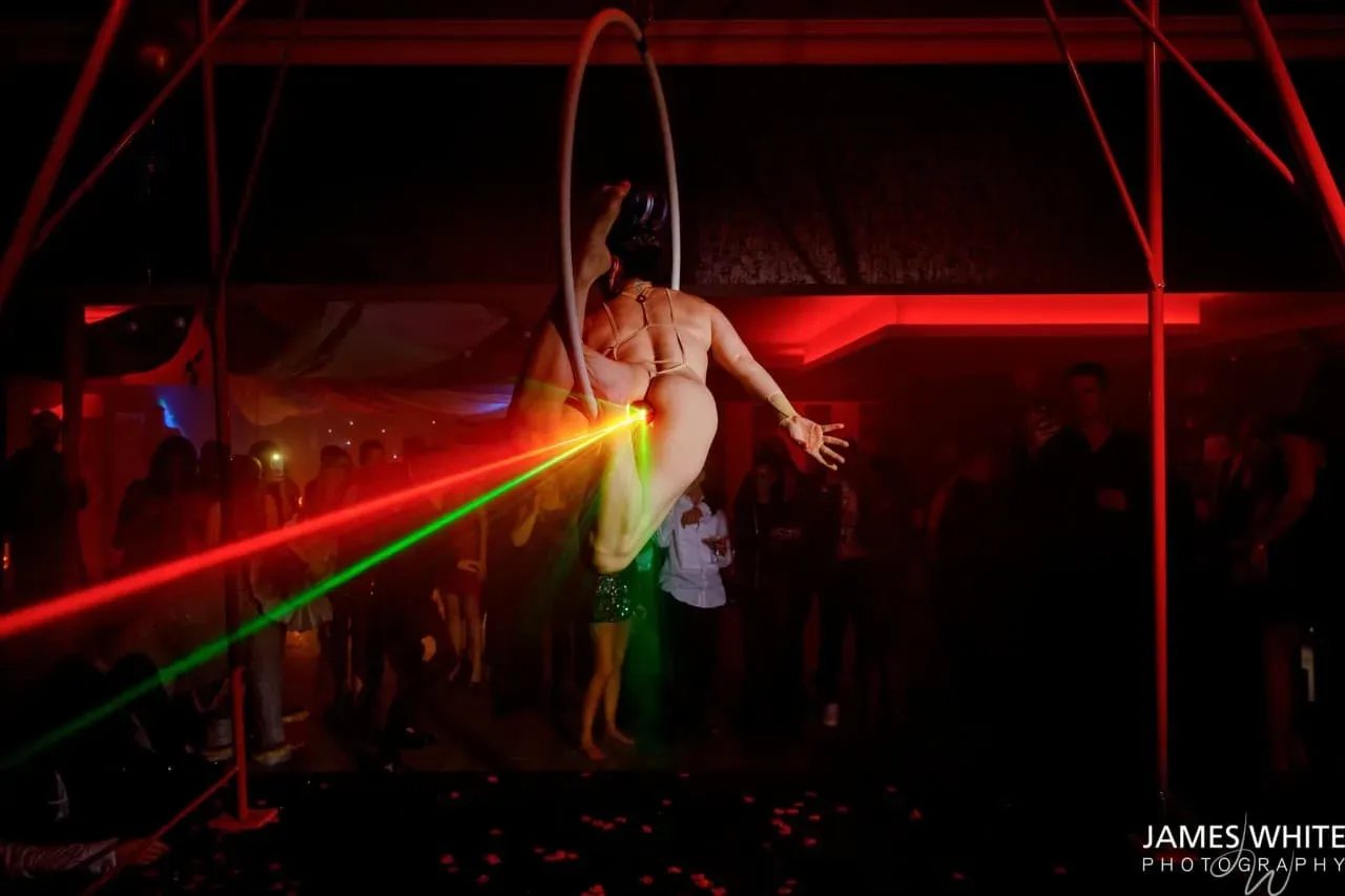 Laser aerial act performing at an evening event